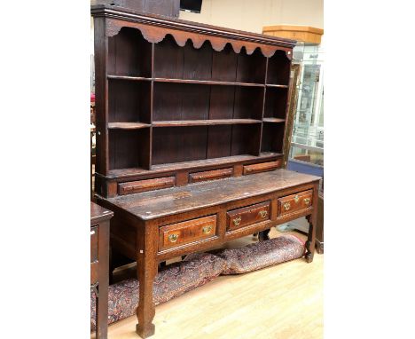 George II solid English oak three drawer dresser with attachable plate rack, three top spice drawers, standing on bracket fee