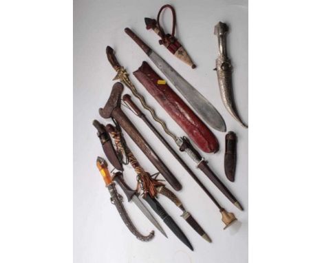 Old Arab white metal mounted and amber hilted Jambia with ornate scabbard and collection of daggers including Indonesian Kris