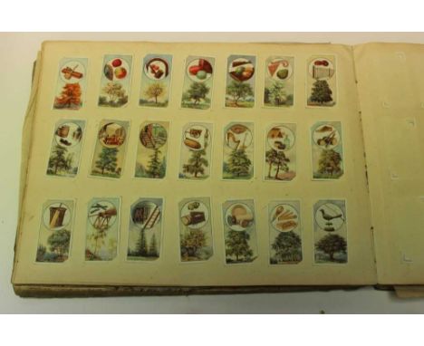 Cigarette Cards - Overseas Issues. Old slip in cut book, containing a large selection of early 20th century cards, various co