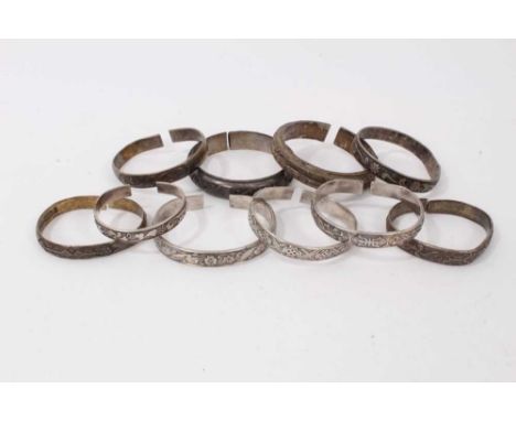 Ten Chinese white metal bangles with floral scroll decorationCondition report: Total weight 377.9 grams (13.33 oz)