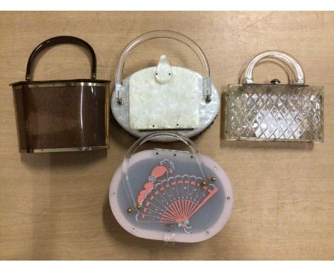 Four vintage c1950's Lucite handbags. Including clear lattice work with rhinestones and bronze coloured bag by Majestic.Condi