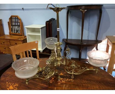 A hanging brass three light chandelier with frosted glass shades