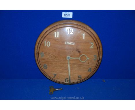 A 1960's Teak dome faced wall Clock with Swiss 18 day movement, gilt hands and Arabic numerals by Zenith, with key.
