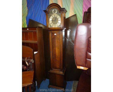 An Oak cased Long case Clock having arched face with selector to the arch for Westminster/St. Michael/Whittington chimes and 