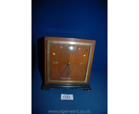 An Art Deco style mantle Clock of square form having quarter-veneered face with Roman numerals at the quarter hour positions,