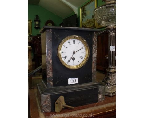 A black marble Clock with Roman numerals and key.