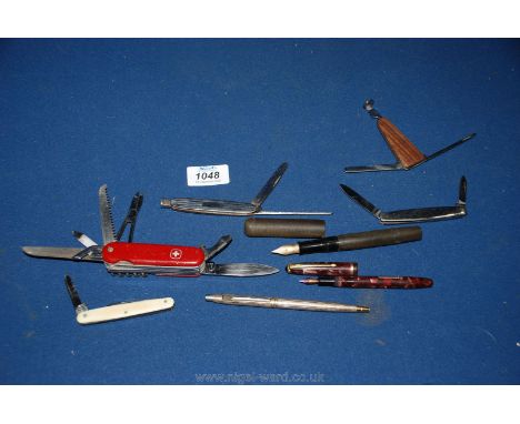 A quantity of miscellanea including a Swiss Army penknife and four others, fountain pens, one in tortoiseshell effect finish,