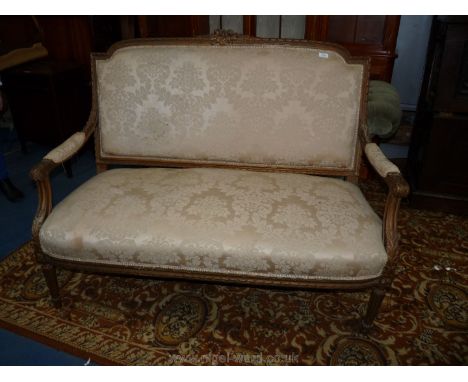 An antique Louis XVI design carved gilt wood Sofa standing on turned and fluted legs and with nicely carved show frame, the t