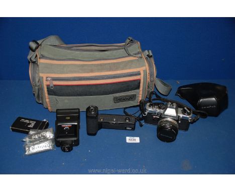 An Olympus OM-10 35 mm SLR camera with Olympus lens, OM-1TR dedicated power wind, Hanimex TZ325 flash gun and lenses all in c