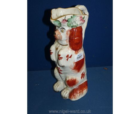 A Staffordshire 19th c. Spaniel dog jug/pitcher ( chip to rim), 10 3/4" tall.