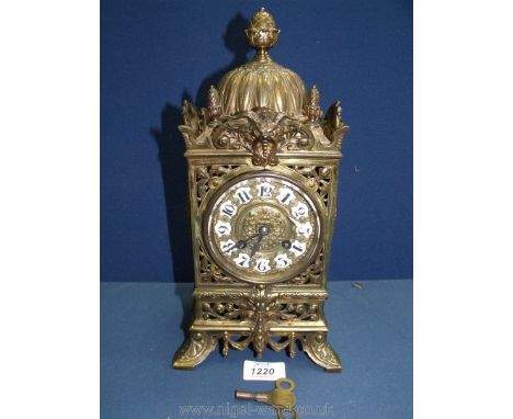 An elegant Brass cased Lantern type mantel Clock having scrolling flowering stem decoration, lion masks detail pediment and d