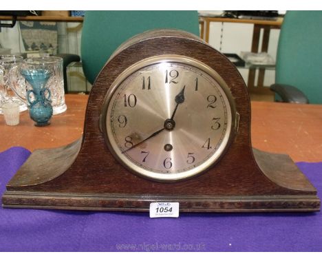 An Oak finished Napoleon's hat shaped Mantel Clock, the face having Arabic numerals, pendulum present, but no winder, 17'' wi