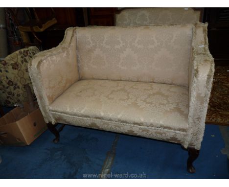 An elegant two seater Sofa, upholstered in cream shadow scrolling foliage pattern satin type fabric, and standing on cabriole