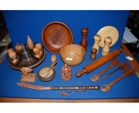 A quantity of Treen including bowls, Buddha, Lazy Susan, condiments, rolling pin, egg cups, spoons etc.