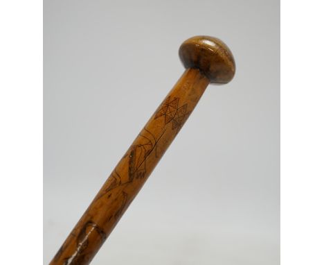 An aboriginal walking stick, inscribed Alice Adelaide, Queenstown, with primitively incised animal and bird imagery, 96cm lon