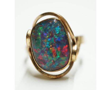 A 9ct? and oval black opal doublet set ring, size Q, gross weight 4.6 grams. Condition - poor Surface wear to stone, not easi