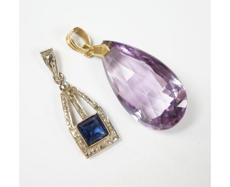 A yellow metal and fancy cut amethyst set drop pendant, 38mm, together with one other blue paste set pendant. Condition - fai