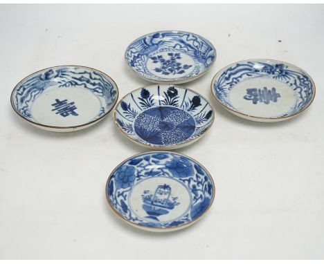 Five variously patterned Chinese blue and white saucer dishes, Kangxi period, largest 16cm diameter. Condition - chips and cr