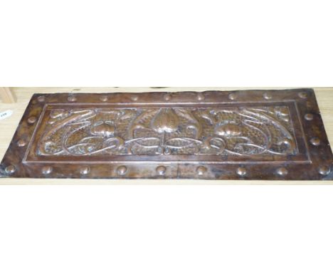 An Art Nouveau copper panel, embossed with stylised flowers and roundels, 39 x 99cm. Condition - fair
