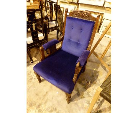Victorian fireside chair with carved detail and ceramic wheels 