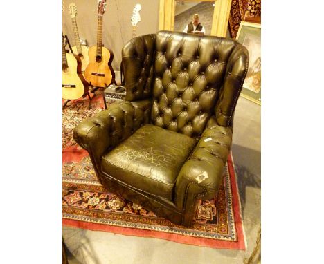 Green leather Chesterfield wing back chair with button back and arms