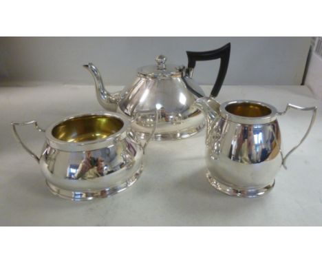 A bachelor's three piece silver tea set  comprising a teapot of squat, bell design with an S-shaped spout, a stylised, ebonis