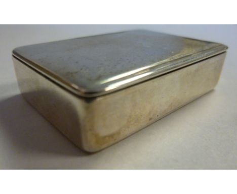 A late Victorian silver snuff box of plain, straight sided rectangular form with a flush fitting, hinged lid and gilded inter