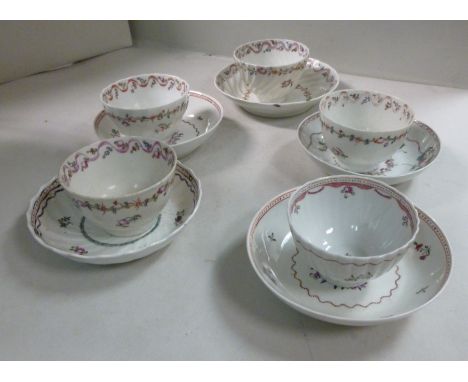 A New Hall porcelain wrythen moulded tea bowl and saucer, decorated with ribbons and floral sprigs; four contemporary, simila