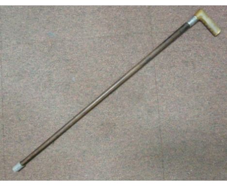 A late 19th/early 20thC walking stick, the tapered shaft with an angled horn handgrip and an engraved silver ferrule  marks r