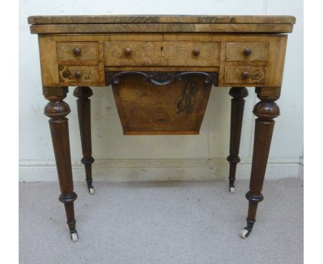 A late Victorian walnut and marquetry games/work table, the fold-over top decorated with a chess board, enclosing a baise lin