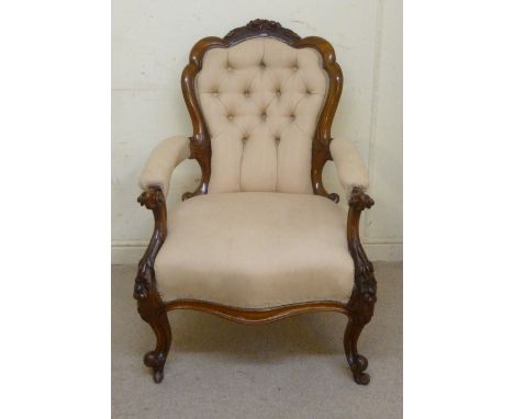 A late Victorian lady's floral and scroll carved mahogany showwood framed lady's spoonback chair with open arms, part button 