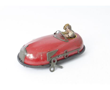 Lindstrom Tinplate Clockwork Dodgem, a printed and painted streamline clockwork dodgem in red livery with two riders, one hea