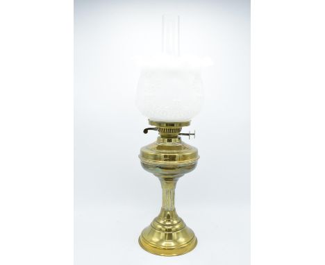 A large Edwardian brass oil lamp complete with an associated funnel and shade. In good condition. Chipping to the funnel, som