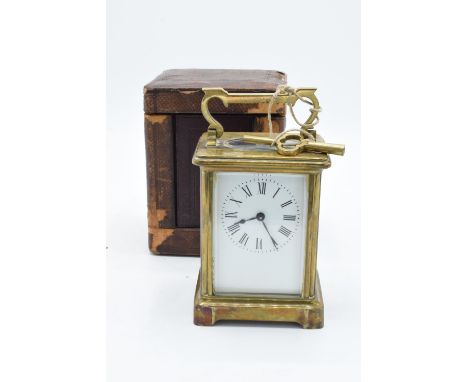 19th century brass carriage clock with an enamel face and a single train movement in a leather travel case. There is some let