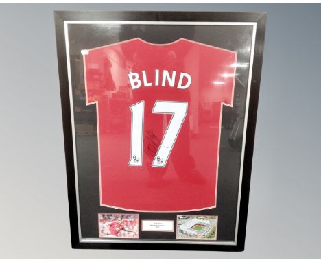 A Daley Blind signed Manchester United shirt with accompanying photographs in mount, framed as one.