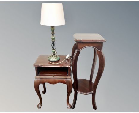 A telephone table on raised legs together with a two tier plant stand, both in a mahogany finish, together with a further Ind