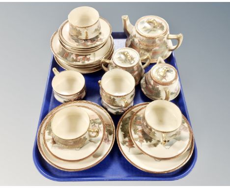 A twenty-one piece Japanese Satsuma earthenware tea service, signed