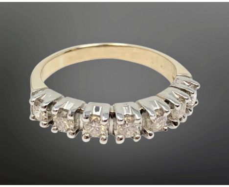 An 18ct gold seven stone diamond half eternity ring, approximately 0.7ct, size P.