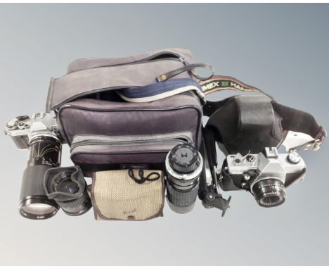 A box containing vintage cameras including Canon AE-1, Praktica MTL3 together with assorted lenses, accessories and camera ba