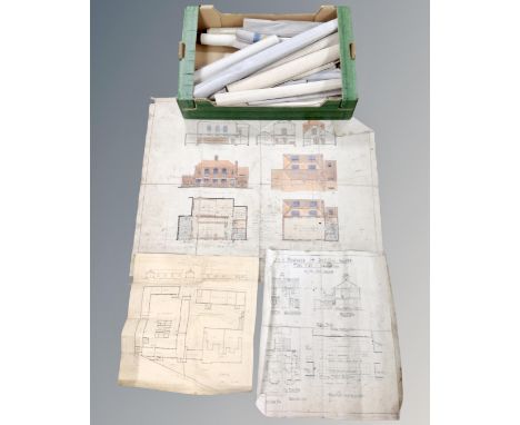A box containing a large quantity of rolled architectural plans.