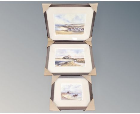 Three signed prints after Tom Macdonald depicting Bamburgh Castle, Lindisfarne and Newbiggin by the Sea, in frames and mounts