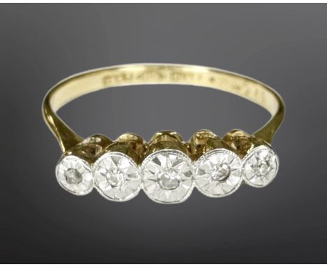 An 18ct yellow gold platinum set five stone diamond ring, size N, 2.2g. CONDITION REPORT: Stones are too small to grade.