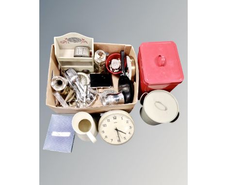 A box containing Metamech quartz wall clock, silver plated, cutlery, painted wooden spice rack, tin storage box and jug.