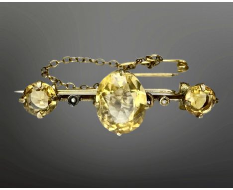 A Victorian yellow metal citrine and seed pearl bar brooch with safety chain, width 37mm.  CONDITION REPORT: 3.2g. Apparently