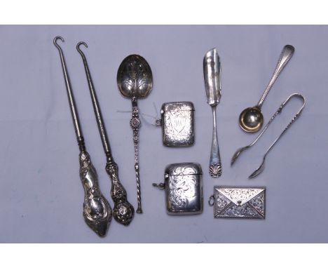 A small quantity of silver items to include anointing spoon B'ham 1910, two vesta cases, stamp case, tongs, two button hooks 