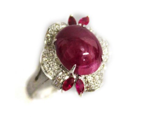 AN UNUSUAL 18CT WHITE GOLD CABOCHON RUBY AND DIAMOND DRESS RING.