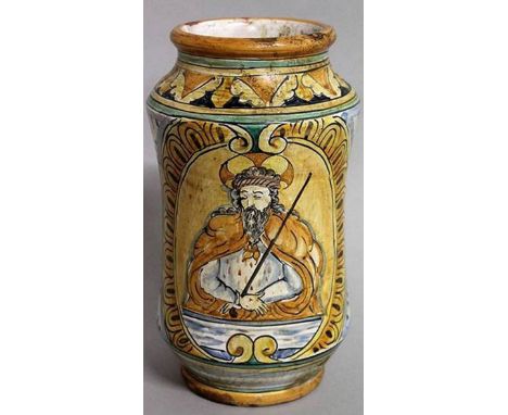 AN ITALIAN TIN GLAZE DRUG JAR painted with a panel of a saint. 10ins high.