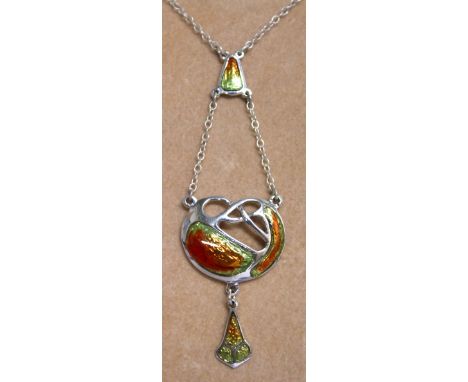 AN ART DECO SILVER AND ENAMEL PENDANT on a chain.