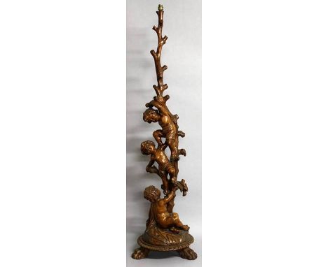 A SUPERB 18TH-19TH CENTURY ITALIAN CARVED WALNUT STANDARD LAMP with three cupids climbing a tree, on a circular base with thr