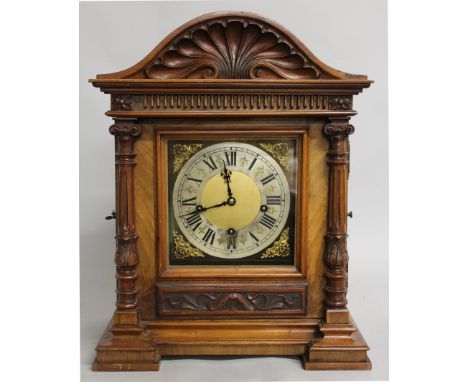 A VICTORIAN WALNUT THREE TRAIN BRACKET CLOCK , with silvered dial, eight-day movement, serpentine top with glass sides and ca